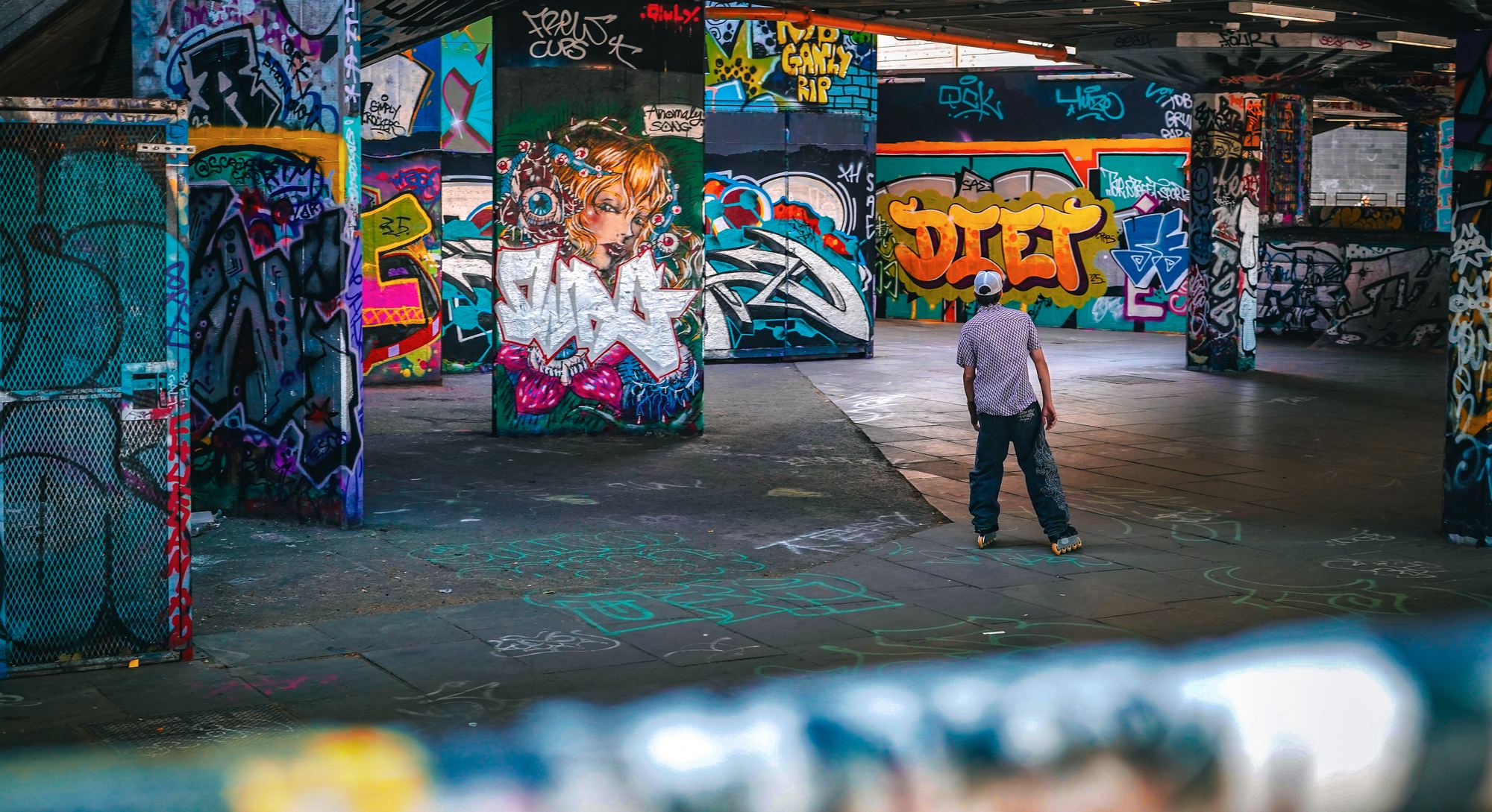 Skater under the graffiti at Southbank, London
